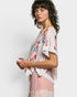 Woman wearing a floral blouse with lace details on a white background