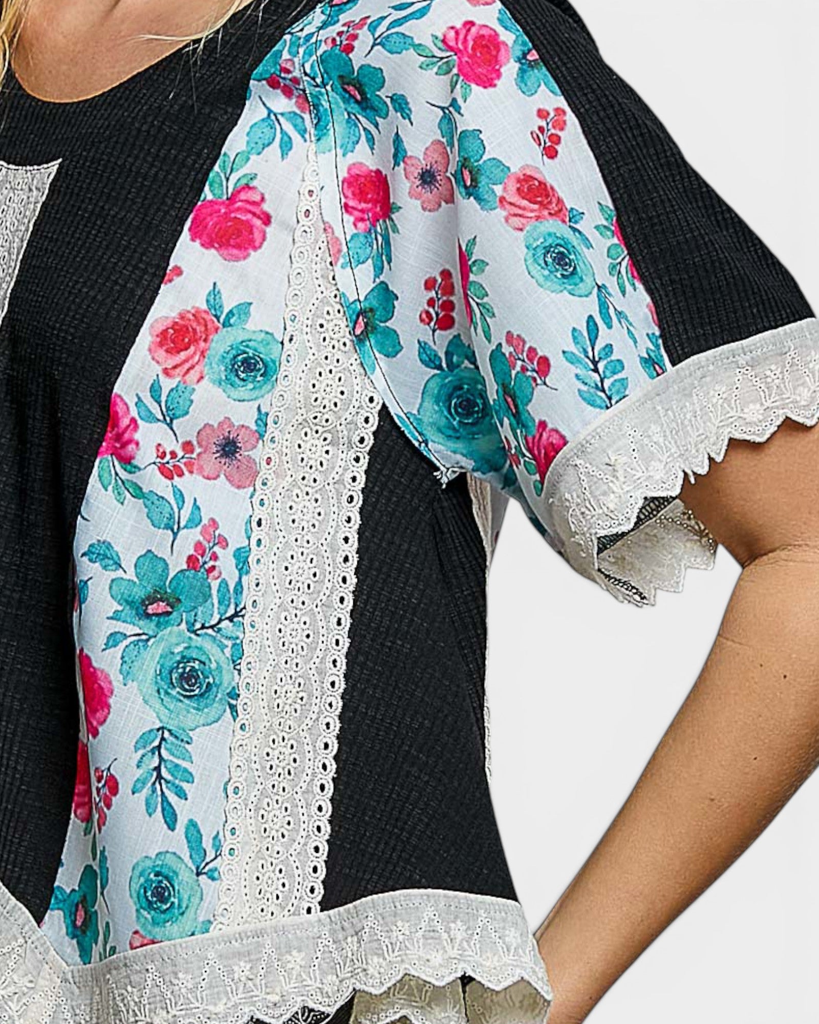Floral blouse with turquoise and pink flowers on a white background