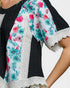 Floral blouse with turquoise and pink flowers on a white background