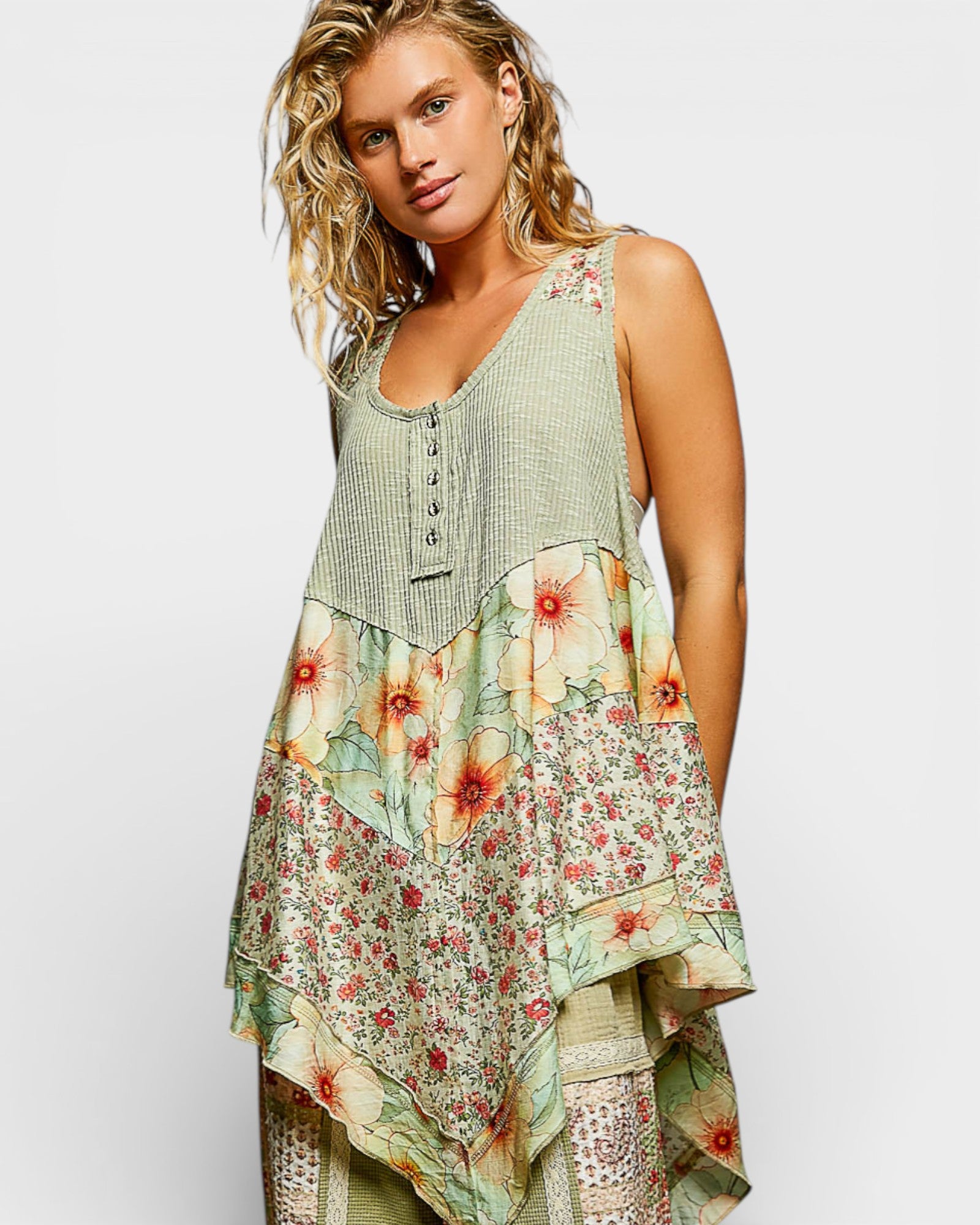 Woman wearing a sleeveless, floral-patterned dress on a white background