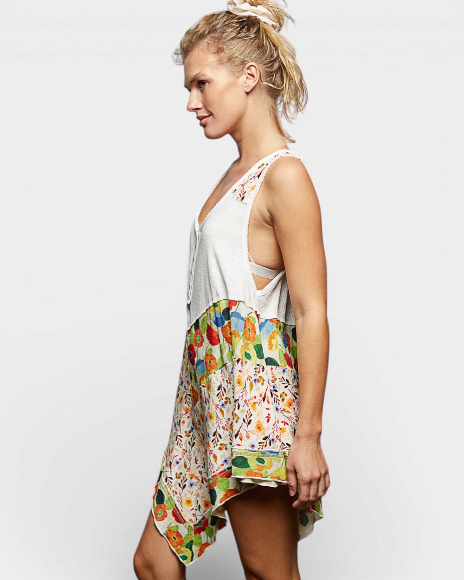 Woman wearing a colorful floral dress on a white background