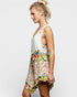 Woman wearing a colorful floral dress on a white background