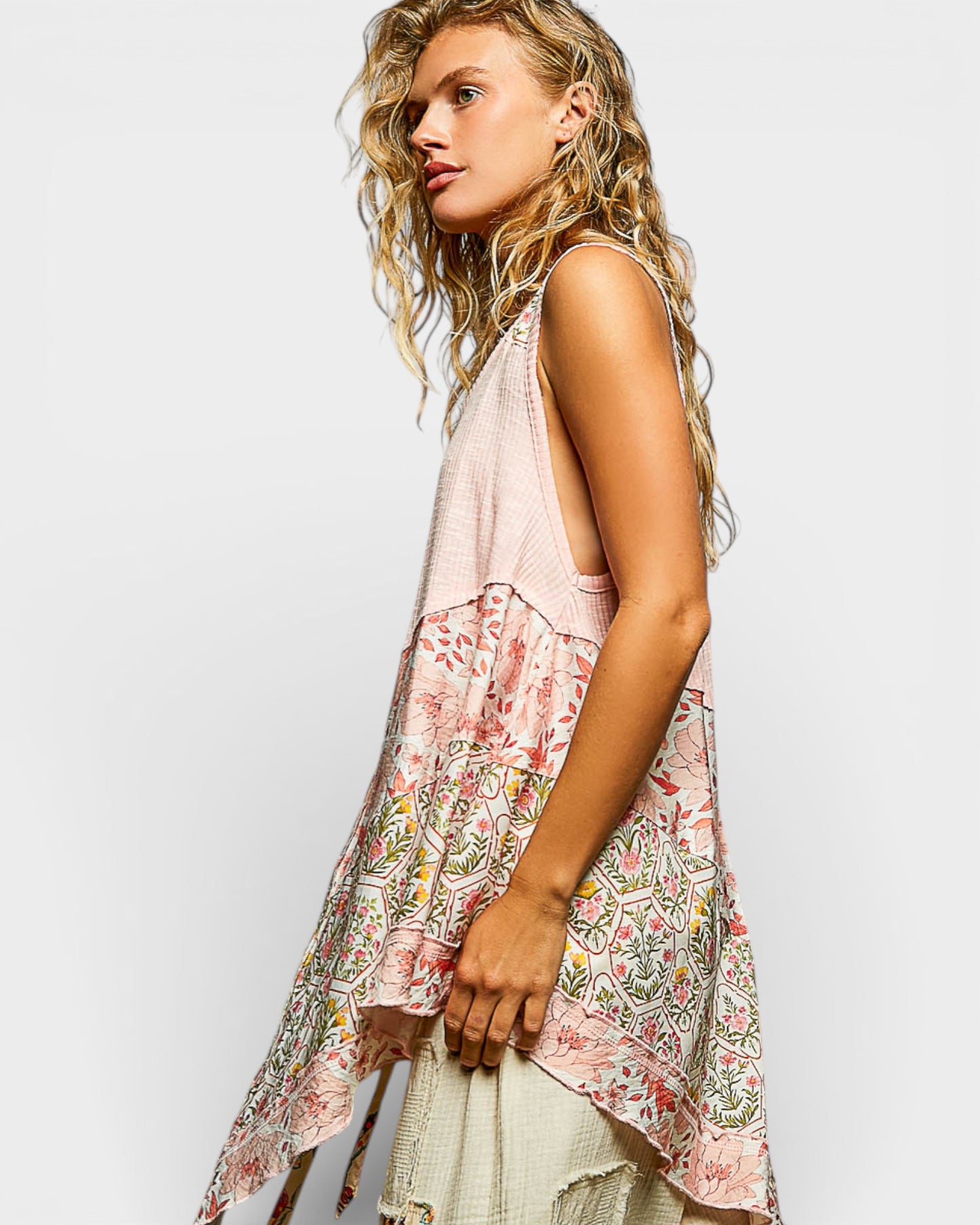 Woman wearing a floral sleeveless top on a white background