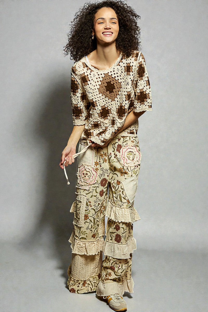 Woman wearing a floral dress with ruffled layers on a gray background