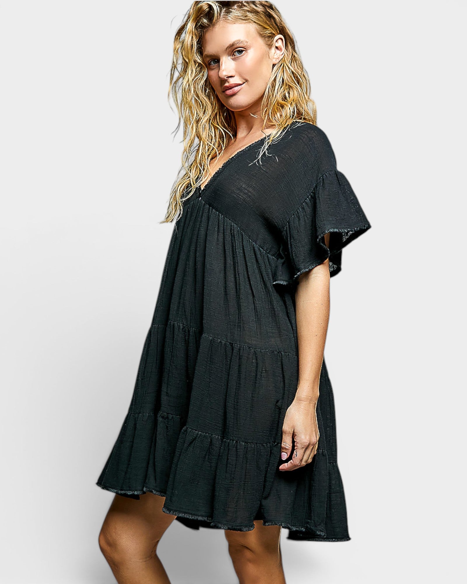Woman wearing a black dress on a white background