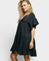 Woman wearing a black dress on a white background