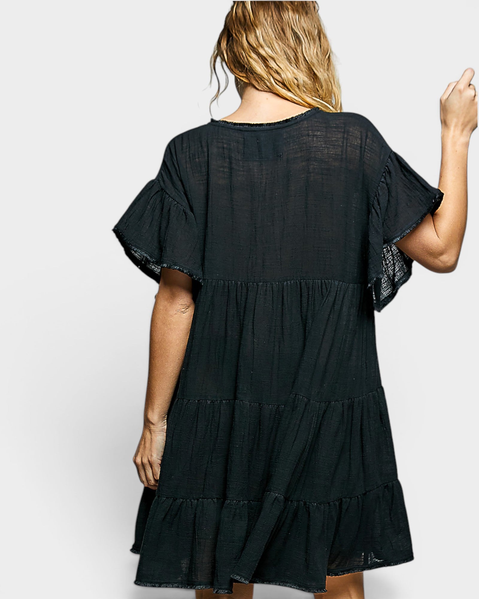 Black dress with ruffled sleeves on a white background