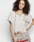 Woman wearing a floral blouse with a plain background