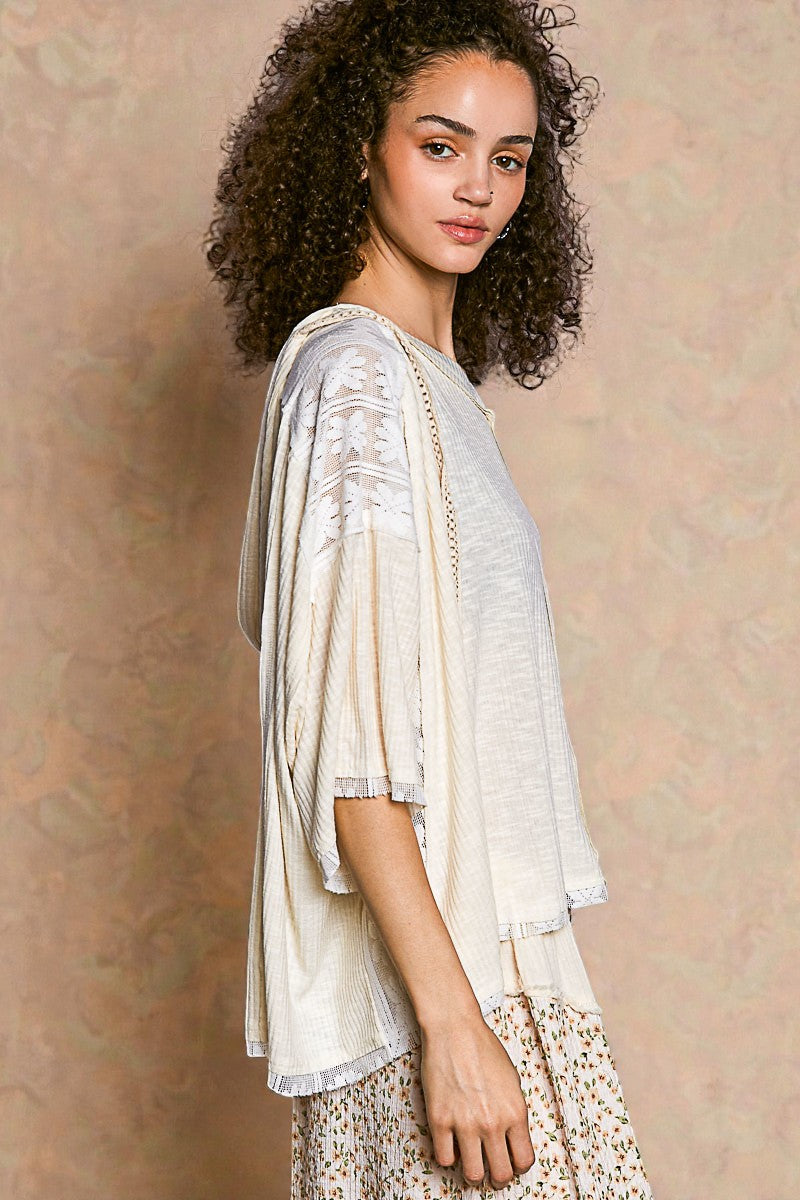 Woman wearing a light-colored top with a textured background