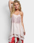 Woman wearing a light pink sleeveless top with floral embroidery on a white background