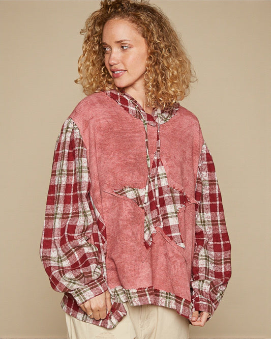 Woman wearing a red plaid shirt against a beige background