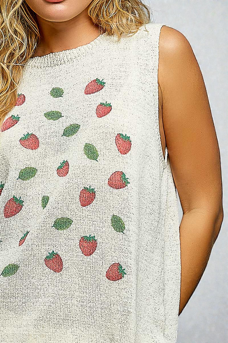 Woman wearing a sleeveless top with strawberry pattern on a plain background