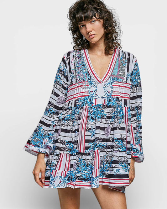 Woman wearing a colorful patterned dress on a white background