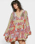 Woman wearing a colorful patterned dress on a white background