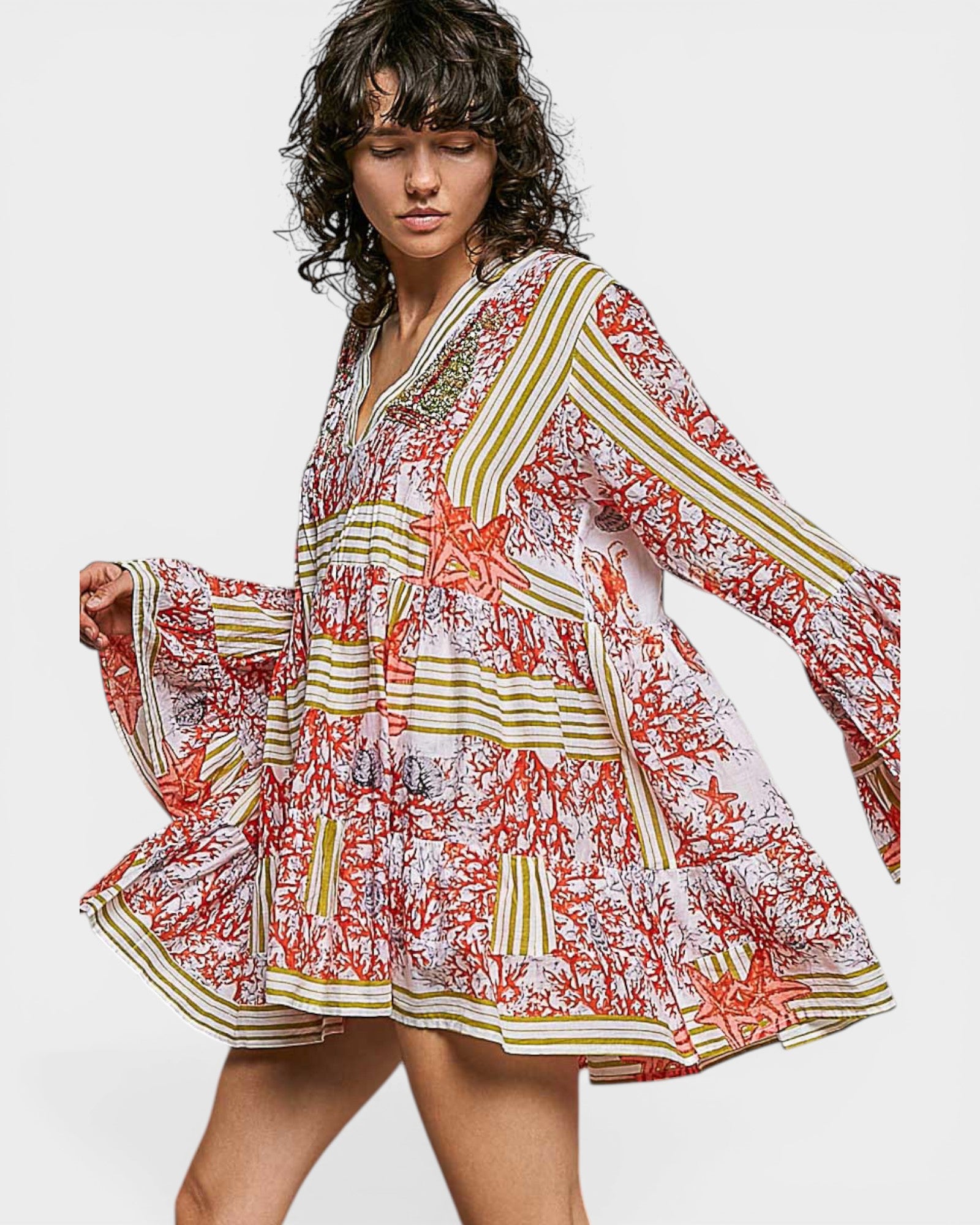 Woman wearing a colorful floral dress on a white background