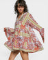 Woman wearing a colorful floral dress on a white background