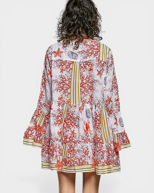 Person wearing a colorful patterned dress on a white background
