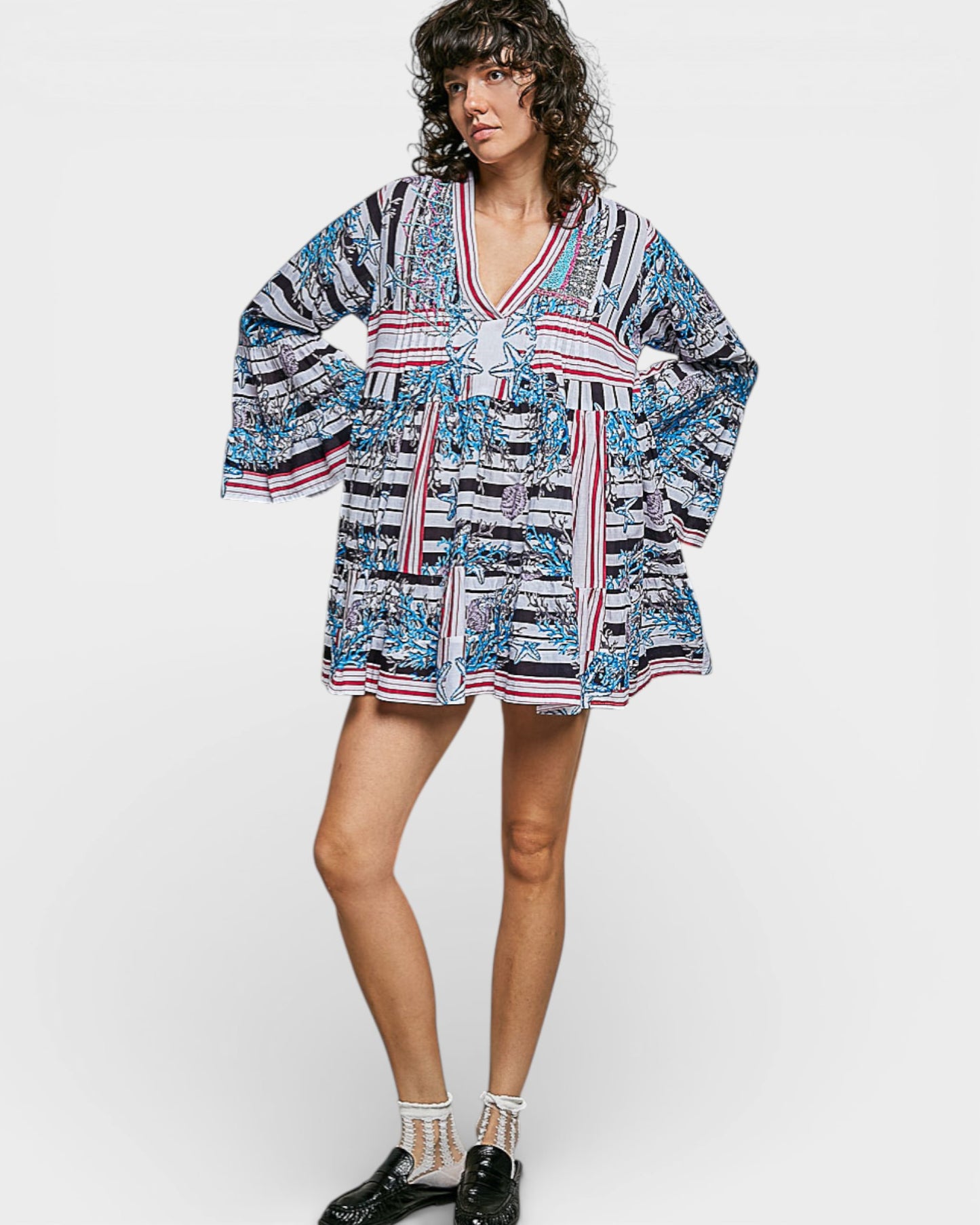 Woman wearing a patterned dress on a white background