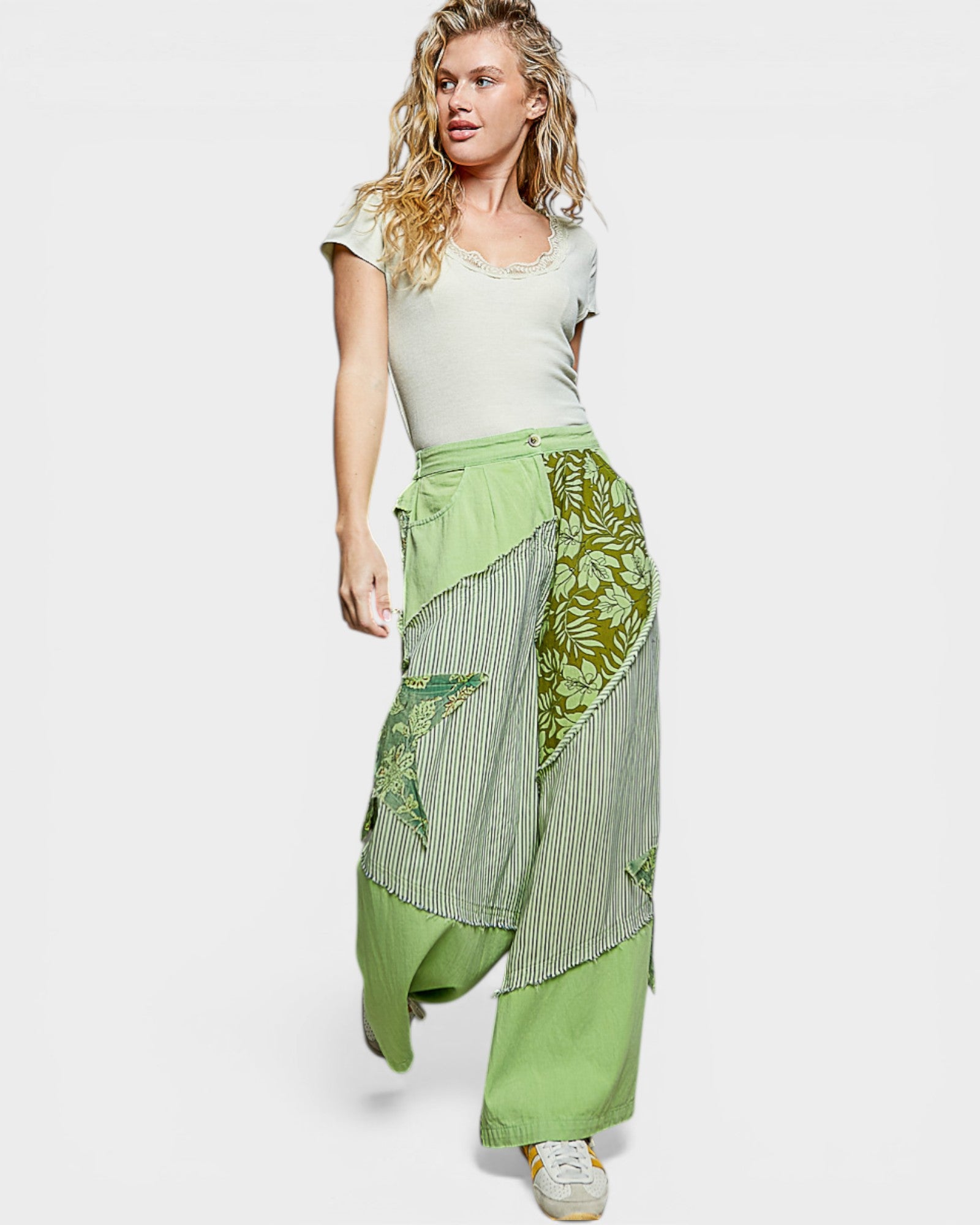 Woman wearing a green patterned skirt on a white background