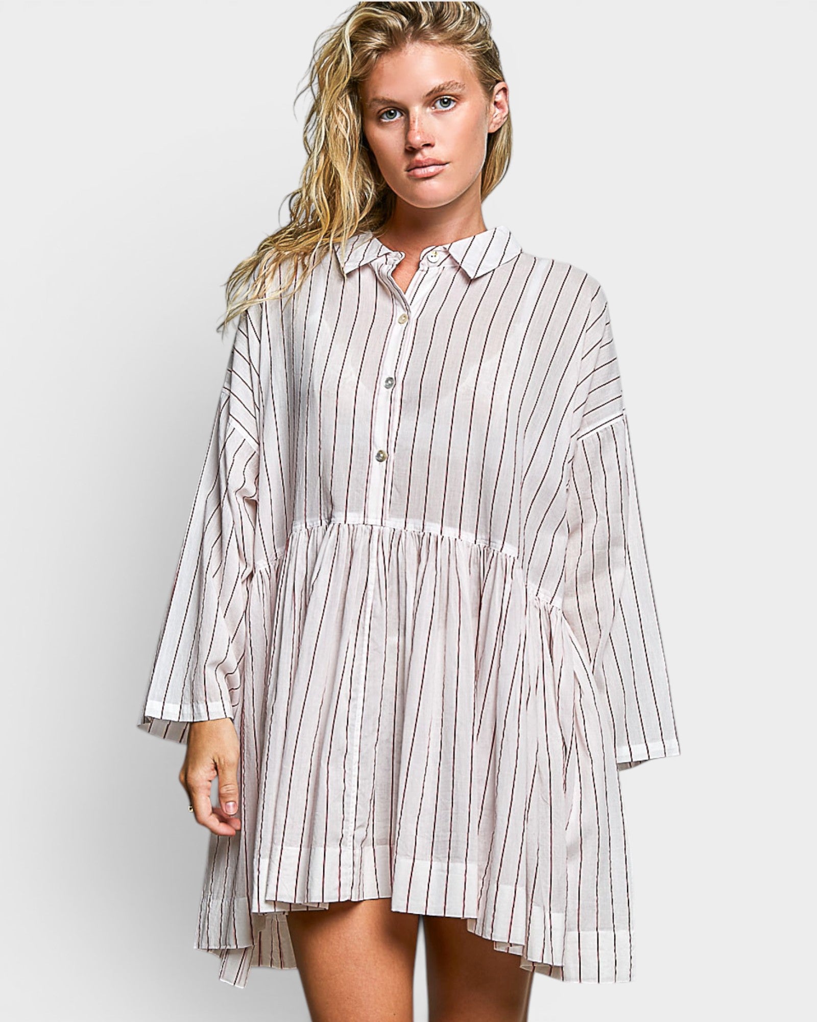 Woman wearing a striped shirt dress on a white background