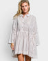 Woman wearing a striped shirt dress on a white background