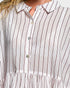 Close-up of a person wearing a white shirt with black vertical stripes.