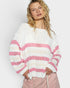 Woman wearing a white and pink striped sweater against a plain background