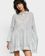 Woman wearing a striped shirt dress on a white background