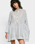 Woman wearing a striped shirt dress on a white background