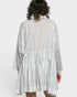 Person wearing a white and navy striped dress on a white background