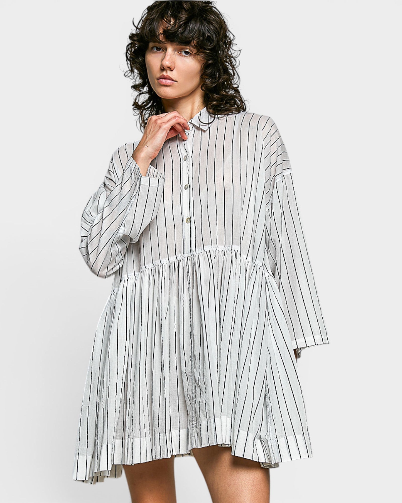 Woman wearing a striped dress on a white background