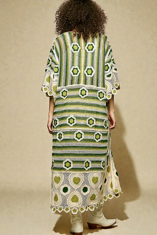 Person wearing a green and white patterned dress against a beige background