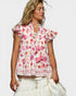 Woman wearing a floral blouse with ruffled sleeves on a white background