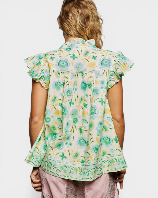 Woman wearing a floral blouse with a white background