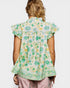 Woman wearing a floral blouse with a white background