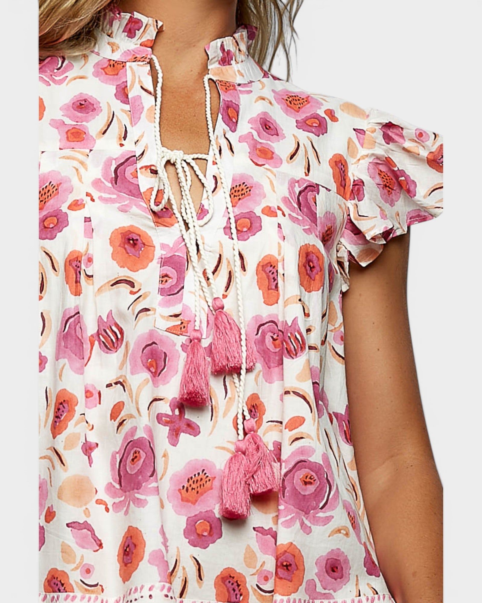 Floral dress with pink tassels on a white background