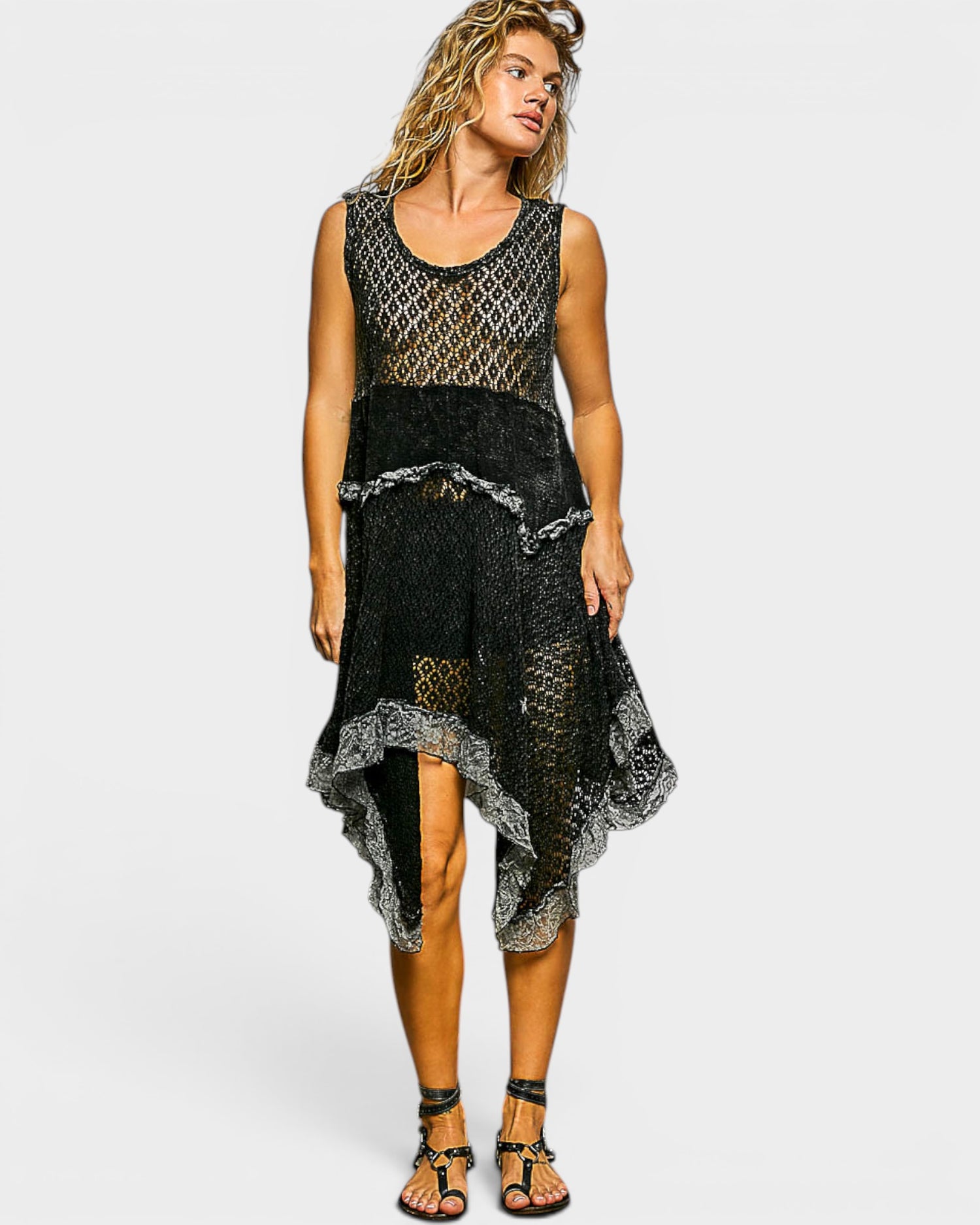 Woman wearing a black lace dress on a white background