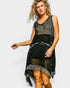 Woman wearing a black lace dress on a white background
