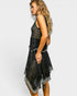 Woman wearing a black and silver patterned dress on a white background