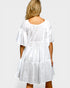 White dress worn by a person on a plain background