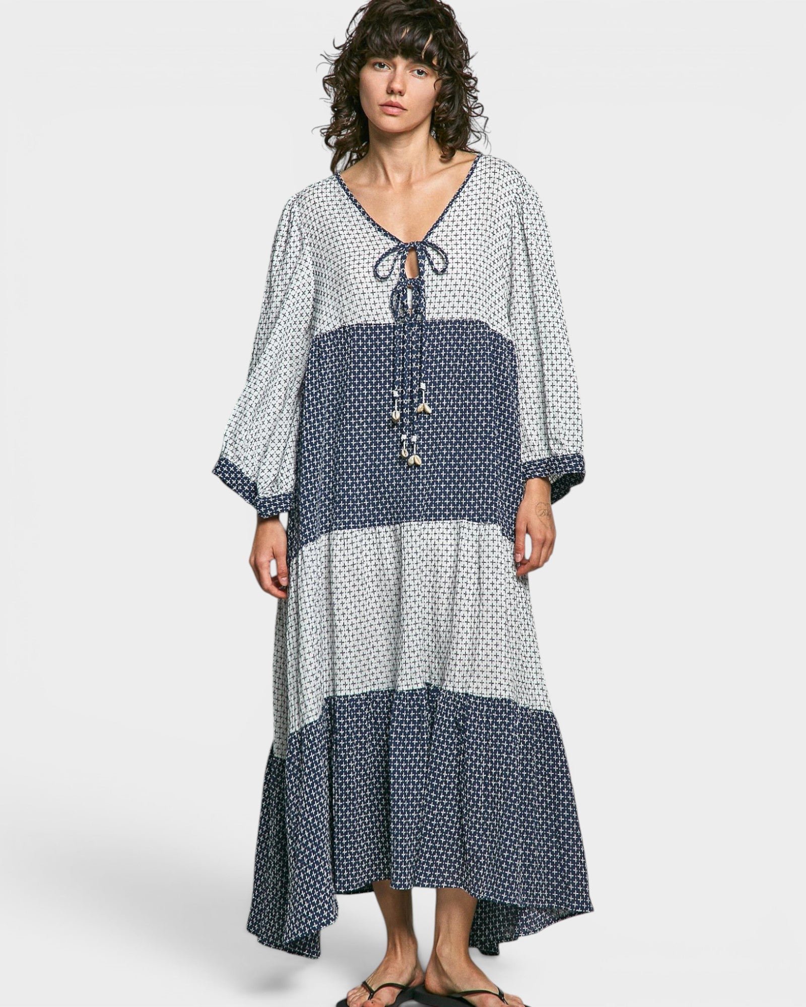 Woman wearing a polka dot dress with a white background
