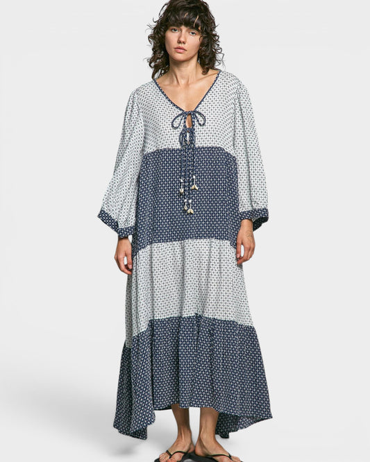 Woman wearing a polka dot dress with a white background