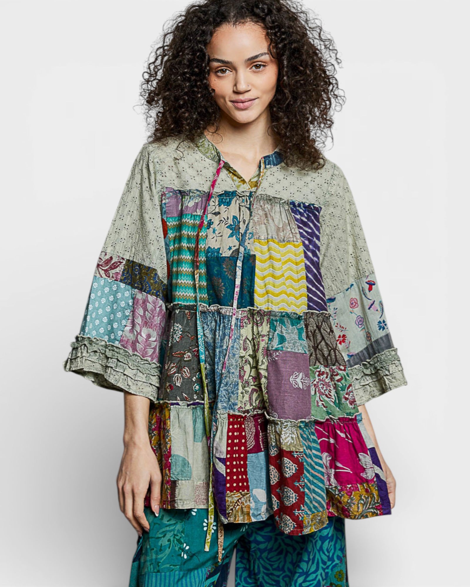 Woman wearing a colorful patchwork jacket on a white background