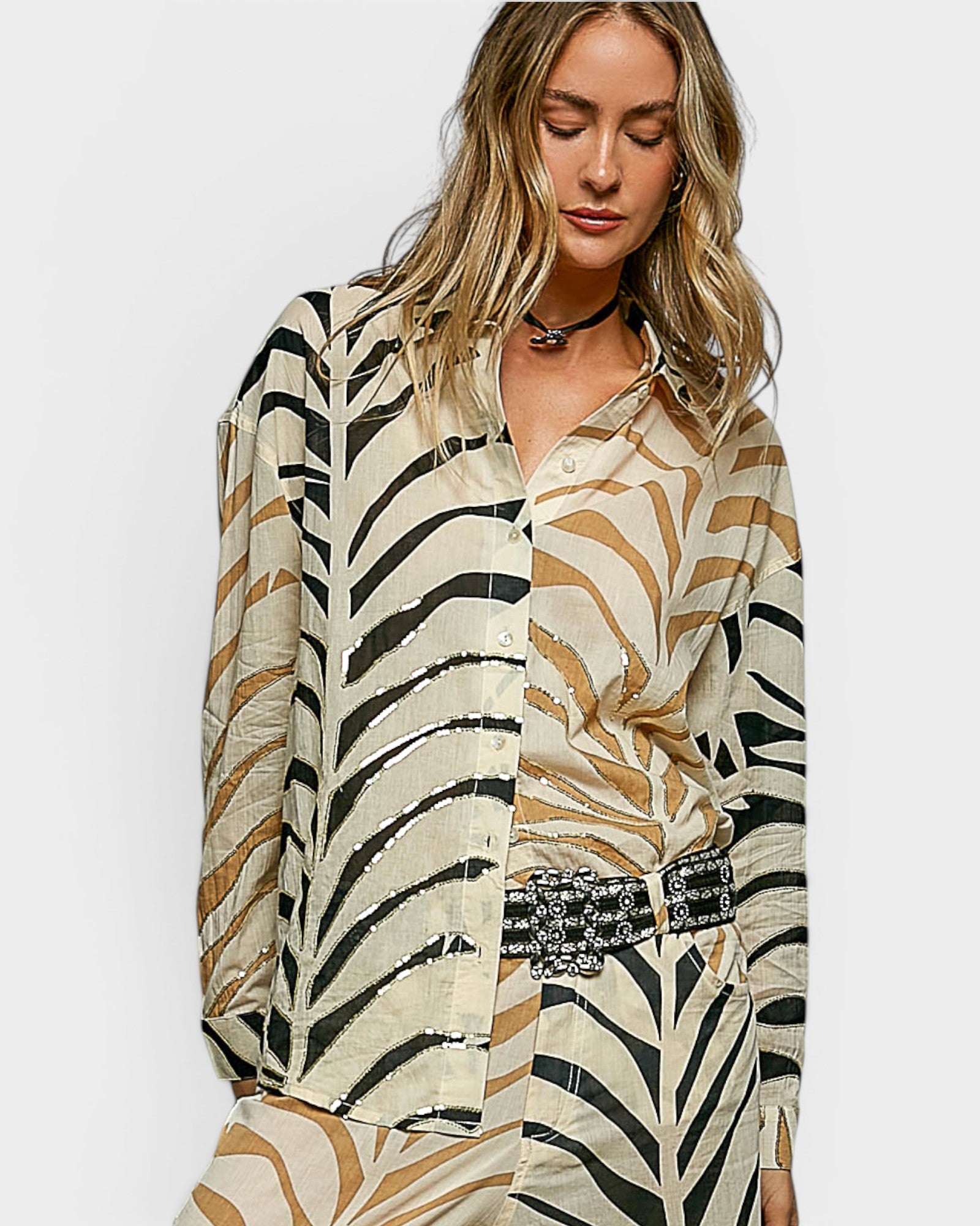 Woman wearing a zebra print outfit on a plain background