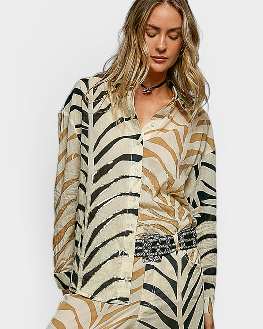 Woman wearing a zebra print outfit on a plain background