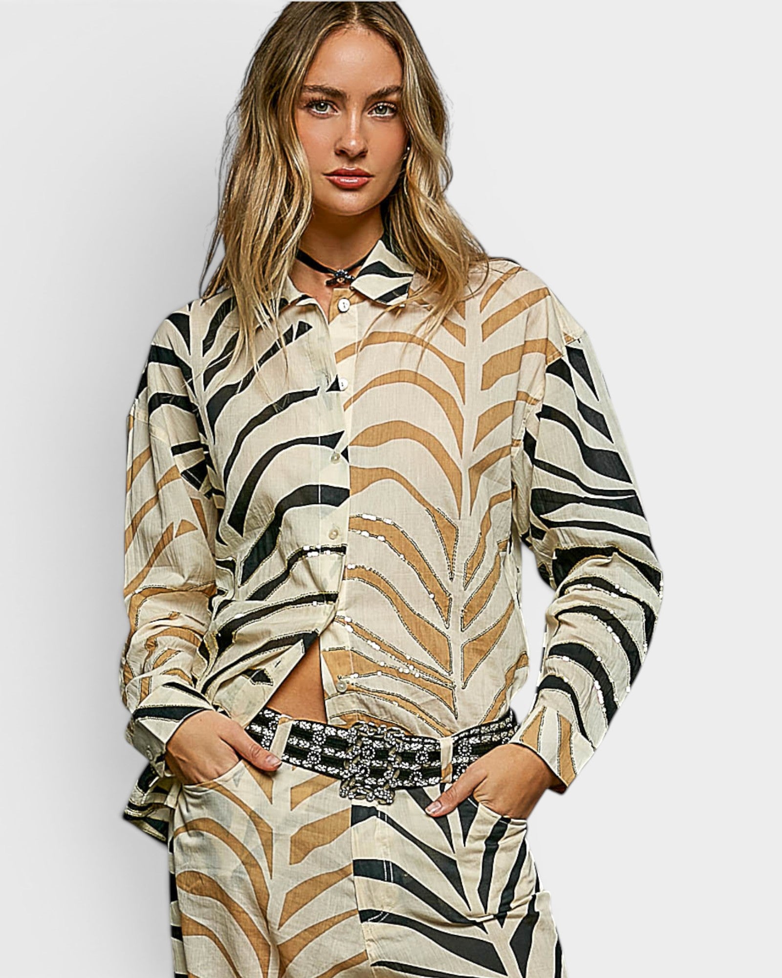 Woman wearing a zebra print outfit on a plain background