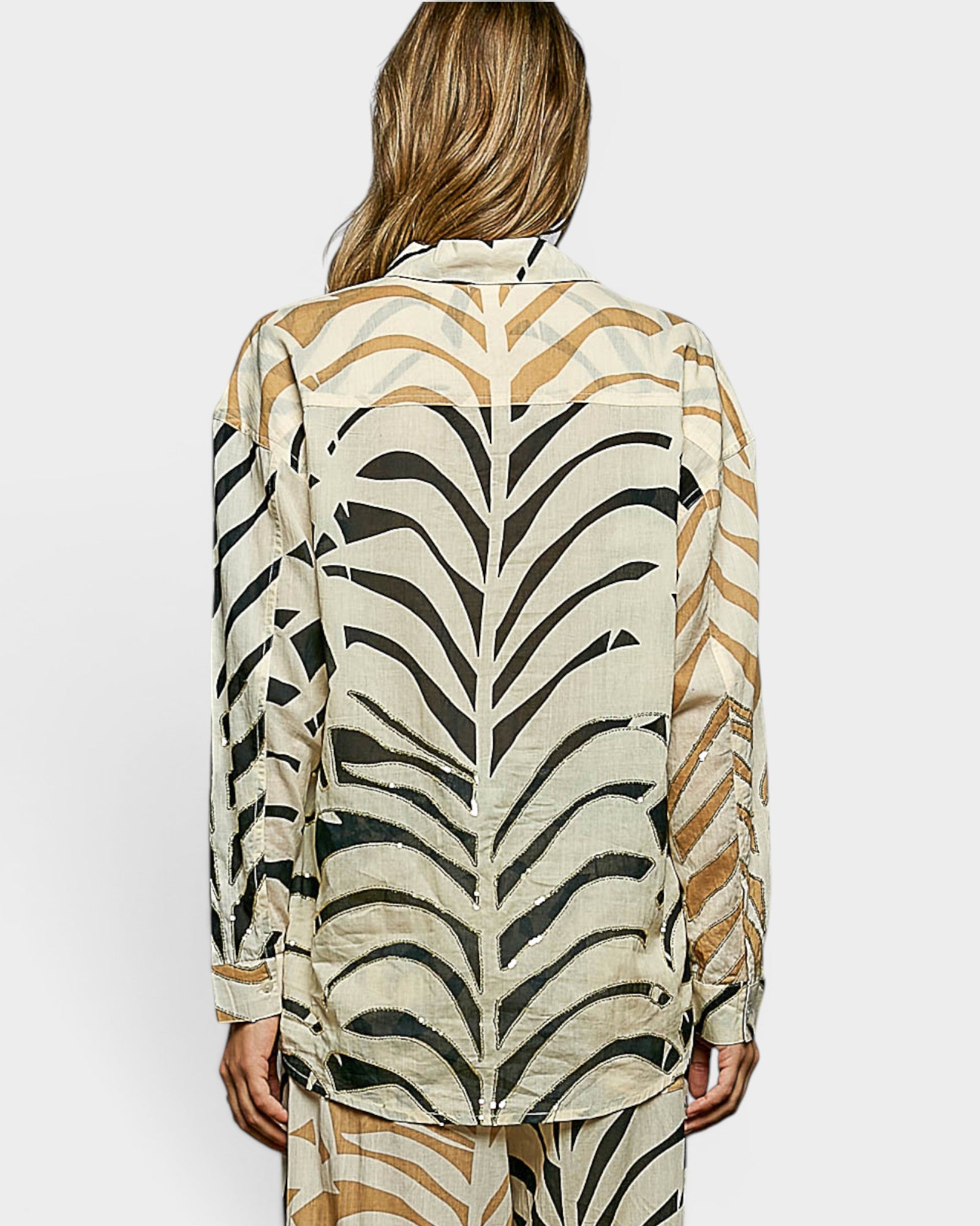 Person wearing a zebra print outfit on a plain background