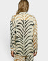 Person wearing a zebra print outfit on a plain background