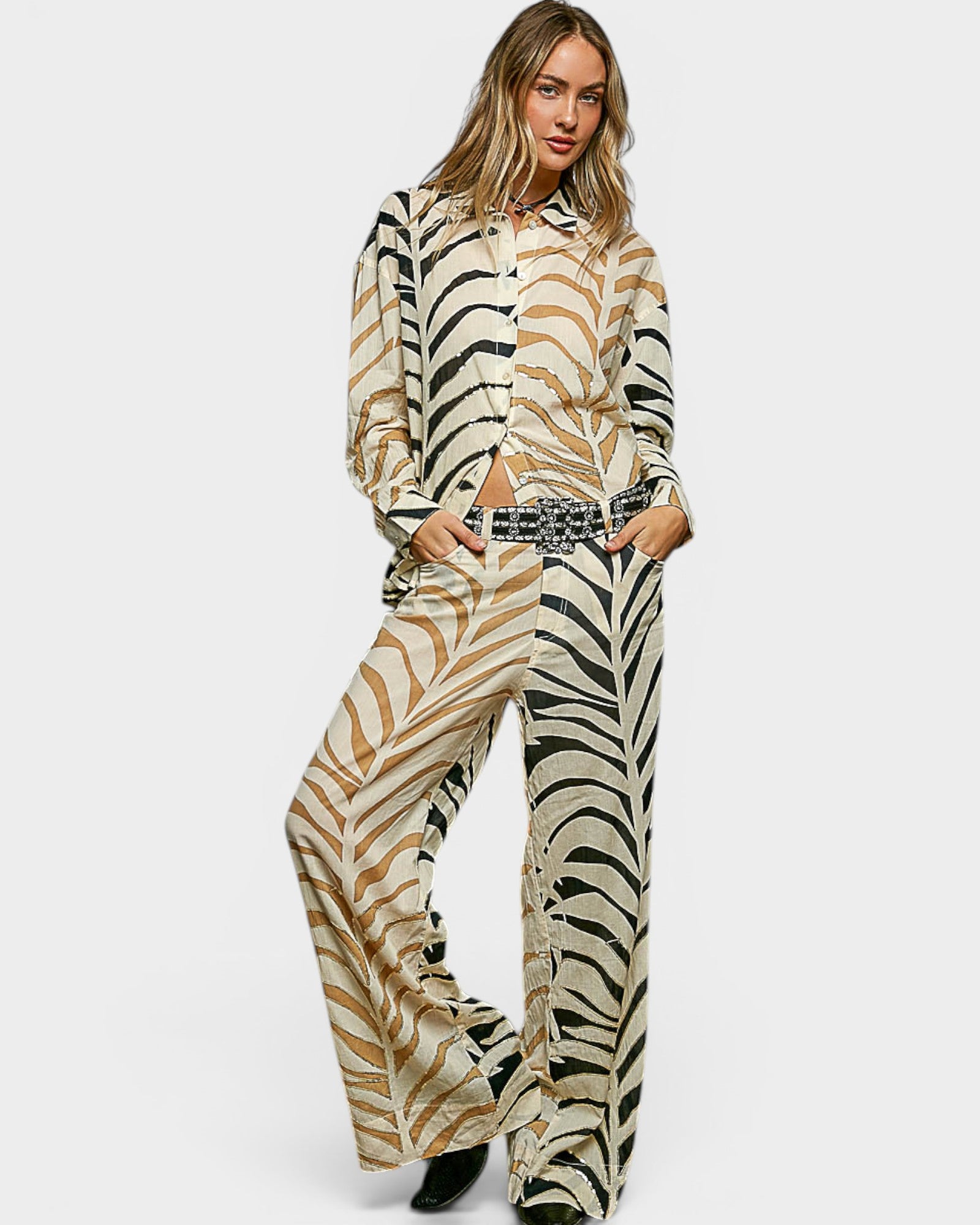 Woman wearing a zebra print outfit on a white background