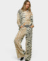 Woman wearing a zebra print outfit on a white background